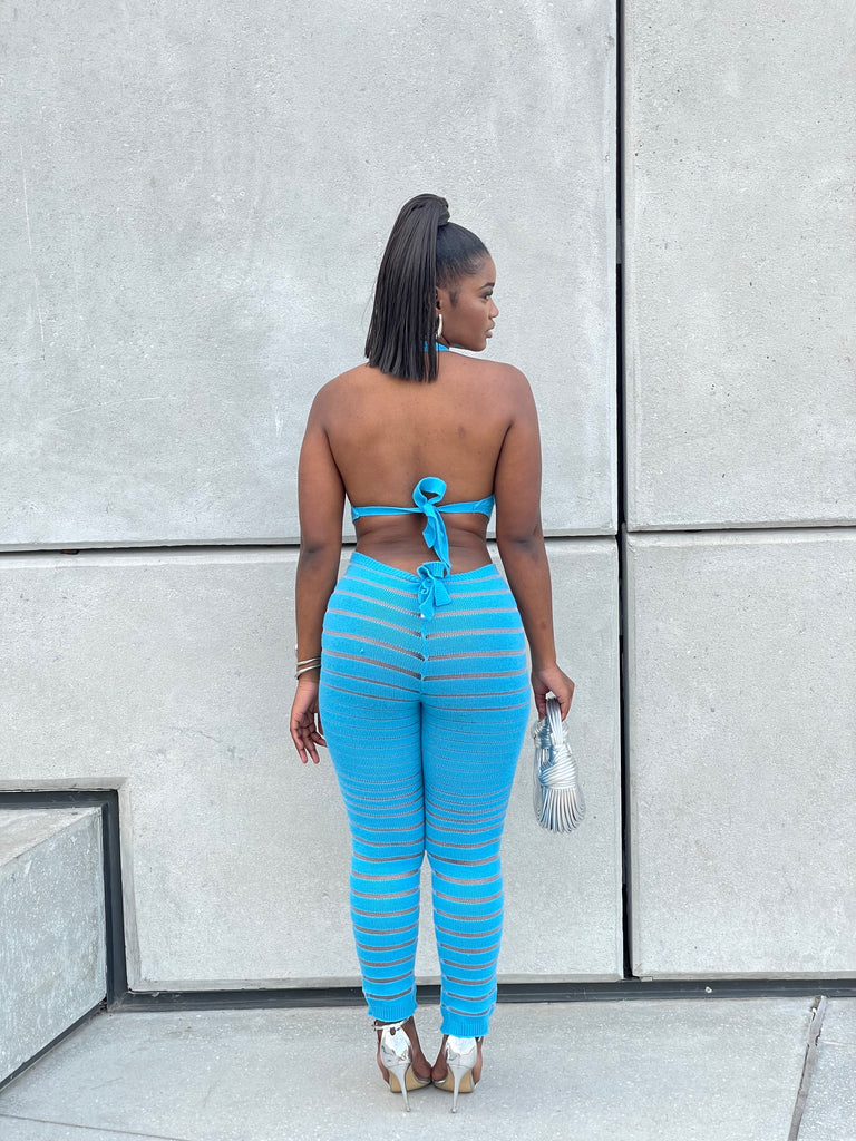 A woman wearing the Reign Striped Leisure Pant Set, highlighting the vibrant blue stripes and comfortable fit, perfect for stylish, relaxed days.