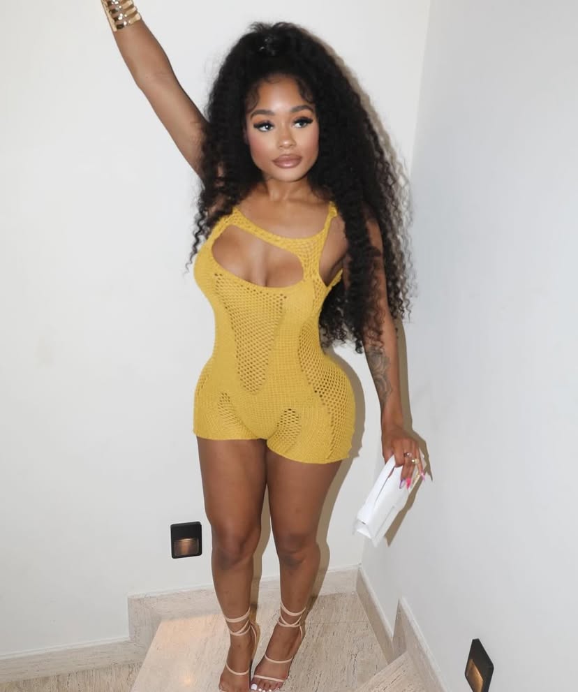 Woman wearing the Amber Mesh Cutout Romper in mustard yellow, featuring mesh fabric and stylish cutouts.