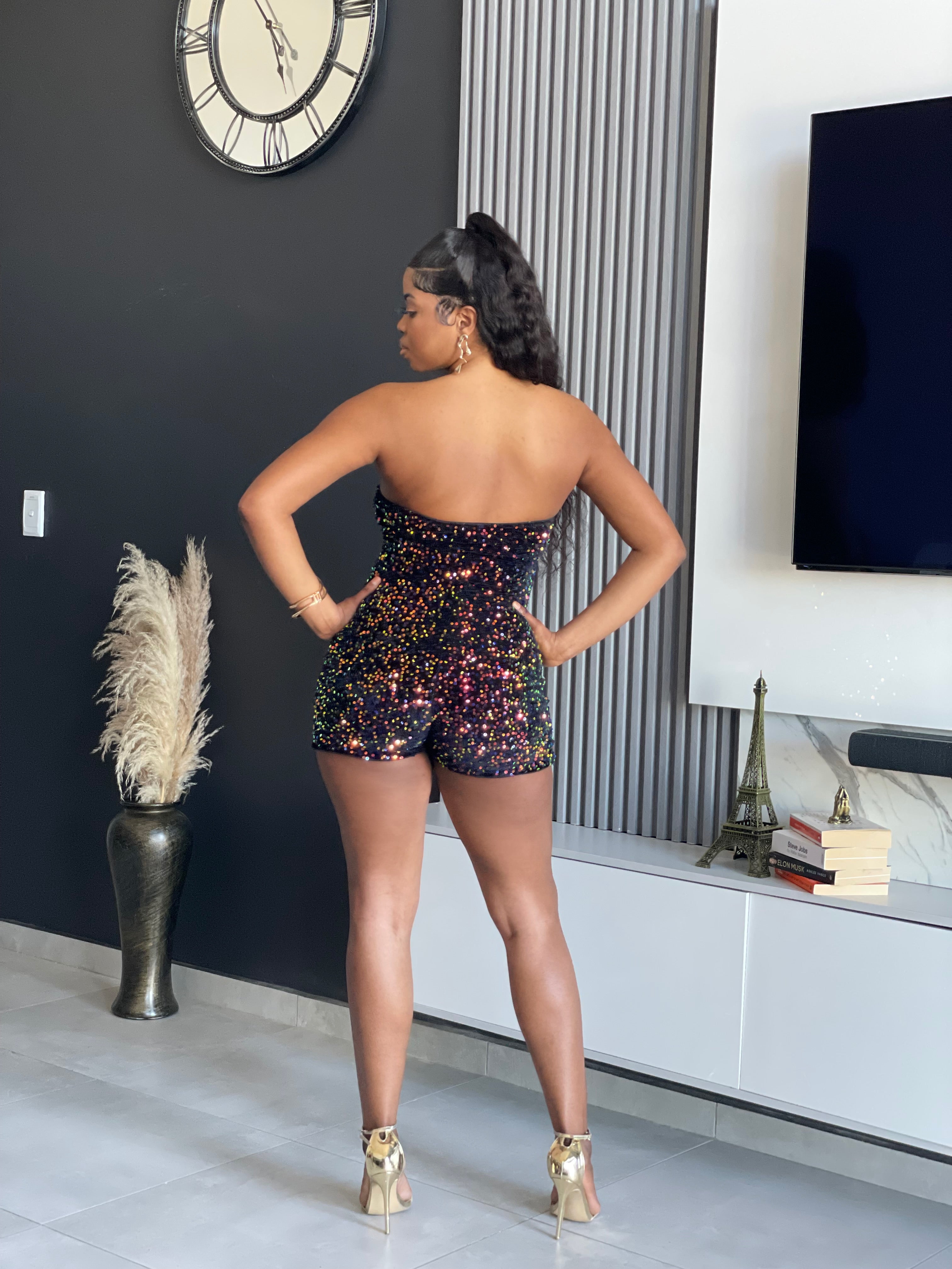 Model wearing the Watch Me Sequin Romper, a strapless, sparkling romper with a zipper front, perfect for special occasions from Vera’s Closet.