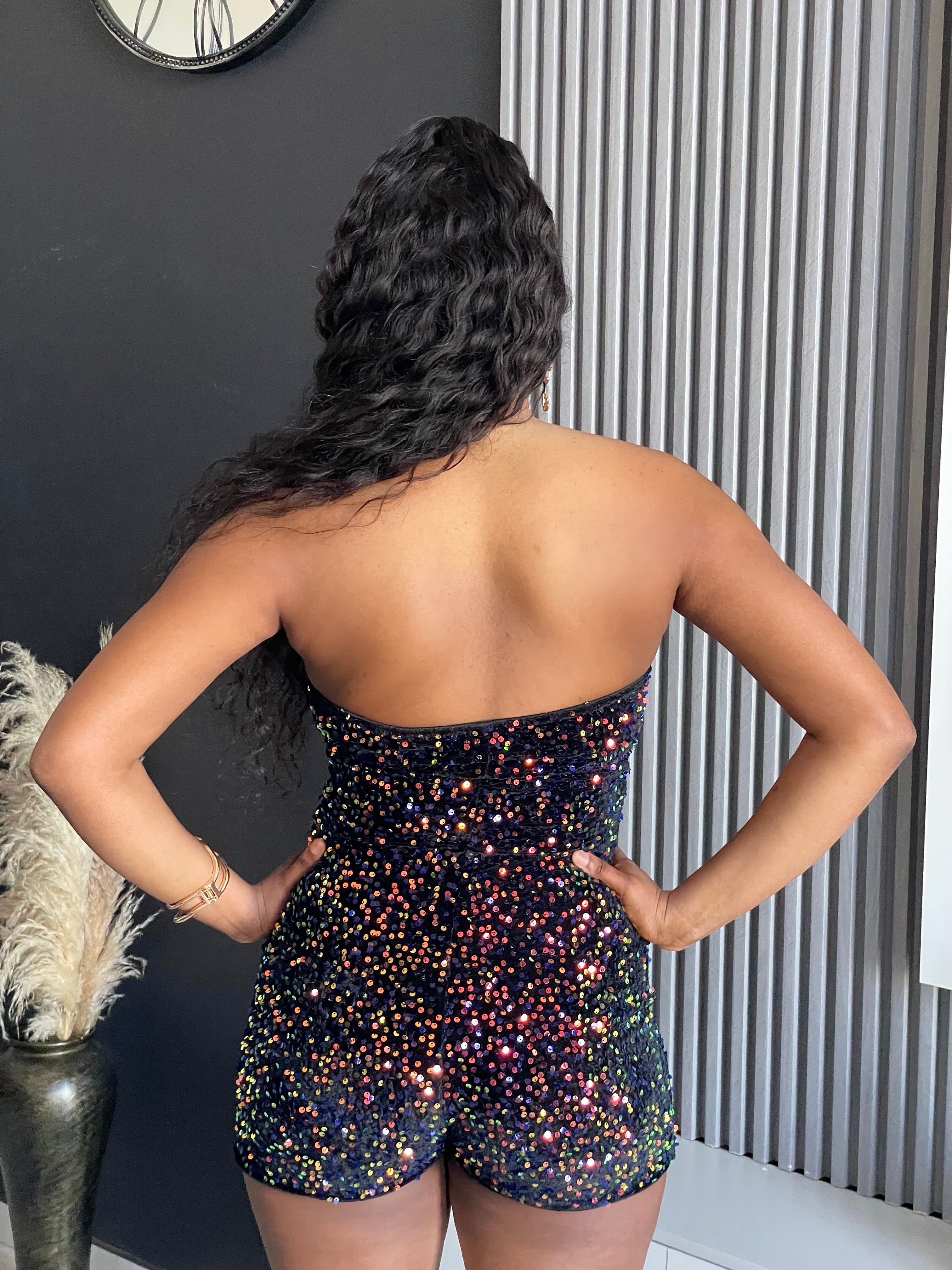 Model wearing the Watch Me Sequin Romper, a strapless, sparkling romper with a zipper front, perfect for special occasions from Vera’s Closet.