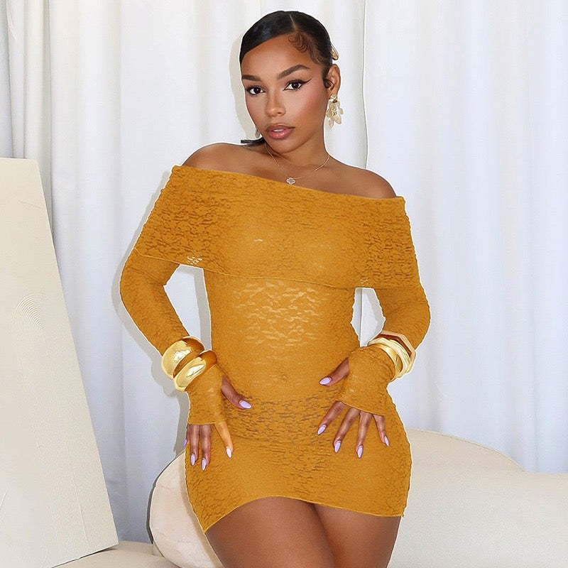 Woman wearing the Fantastic Off-Shoulder Lace Mini Dress in mustard yellow, featuring sheer lace, a bold off-shoulder neckline, and long sleeves.