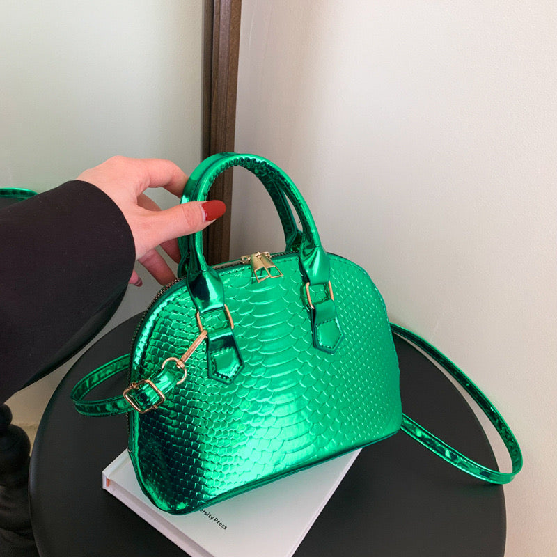 Metallic croc-embossed Mini Luxe Croc Bag in vibrant colors with adjustable strap, perfect for parties and casual outings.