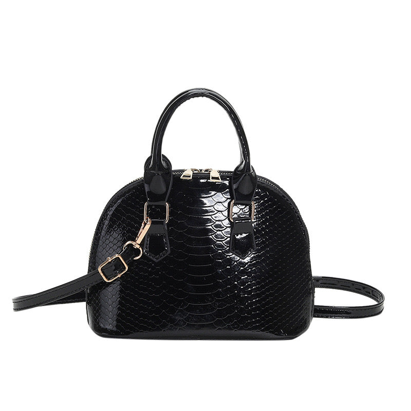 Metallic croc-embossed Mini Luxe Croc Bag in vibrant colors with adjustable strap, perfect for parties and casual outings.