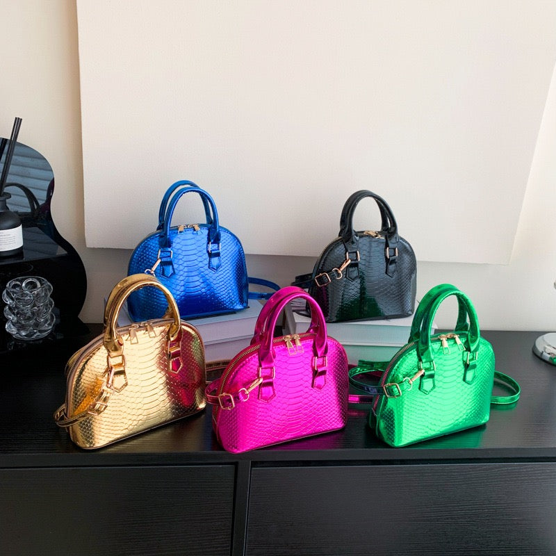 Metallic croc-embossed Mini Luxe Croc Bag in vibrant colors with adjustable strap, perfect for parties and casual outings.