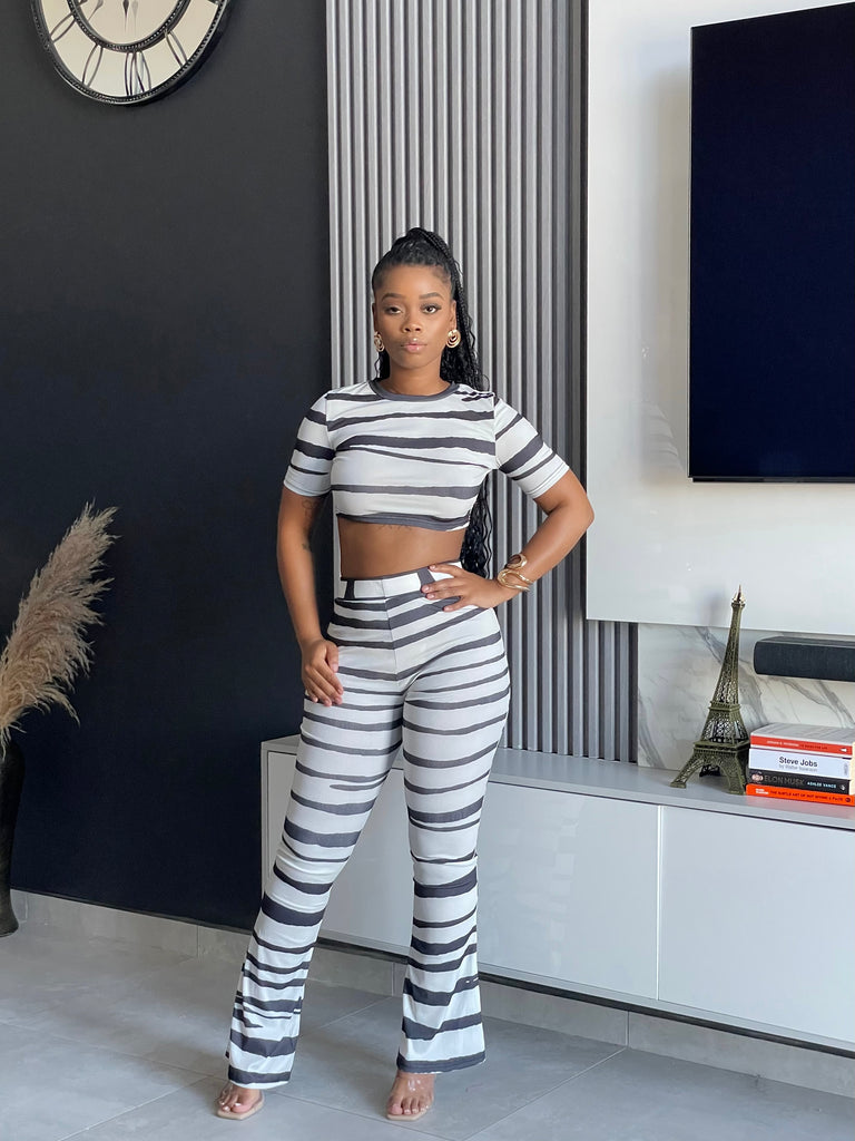 Model wearing the Chantra Striped Pant Set, a two-piece outfit with trendy stripes from Vera’s Closet.