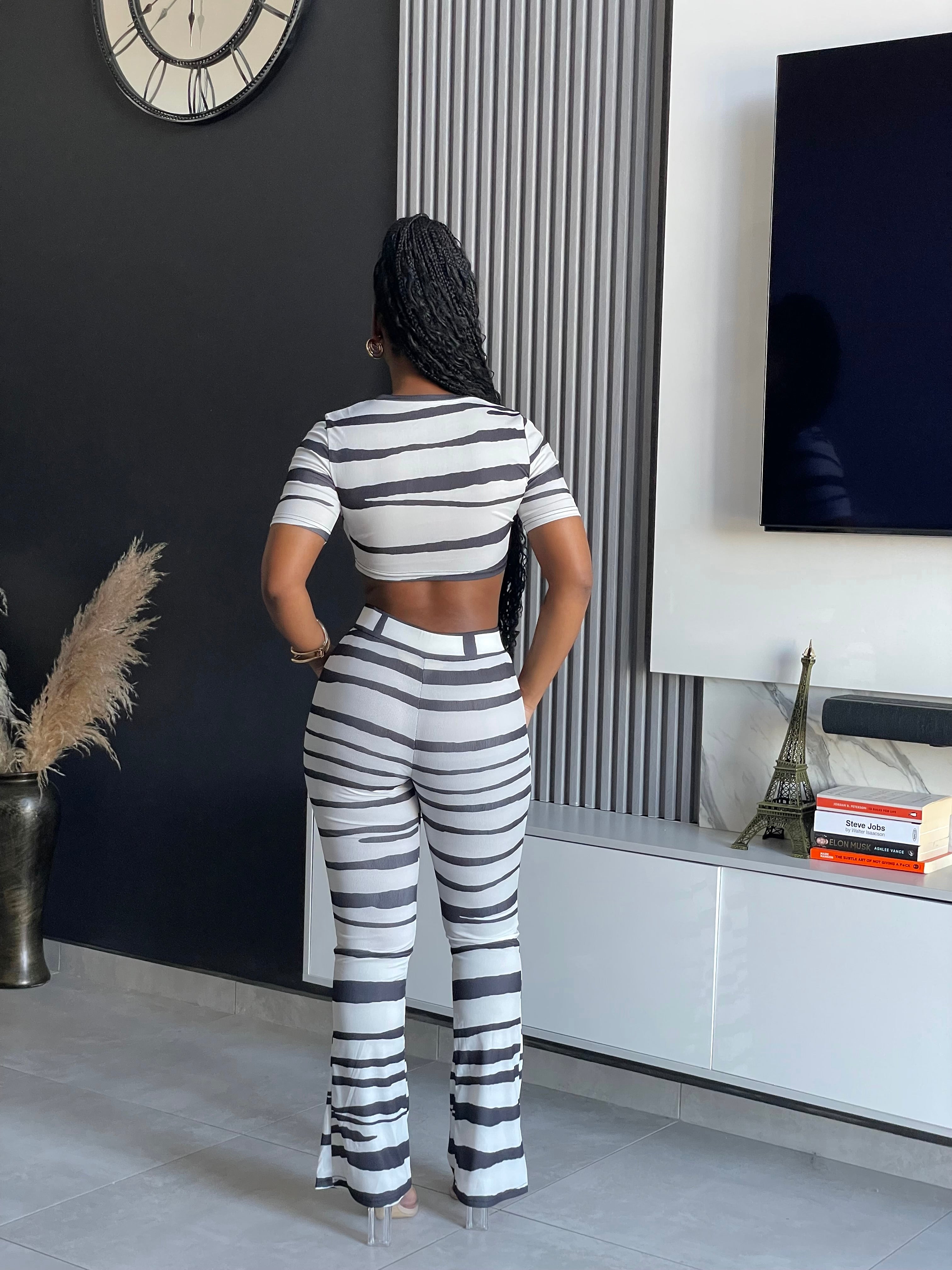 Model wearing the Chantra Striped Pant Set, a two-piece outfit with trendy stripes from Vera’s Closet.