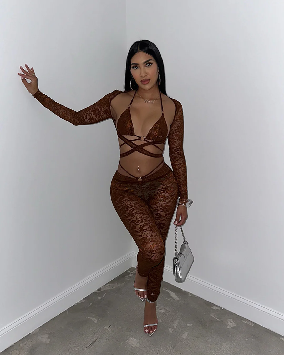 Woman wearing Gosh Pant Set, a brown lace pant set with intricate detailing and stylish cutouts.