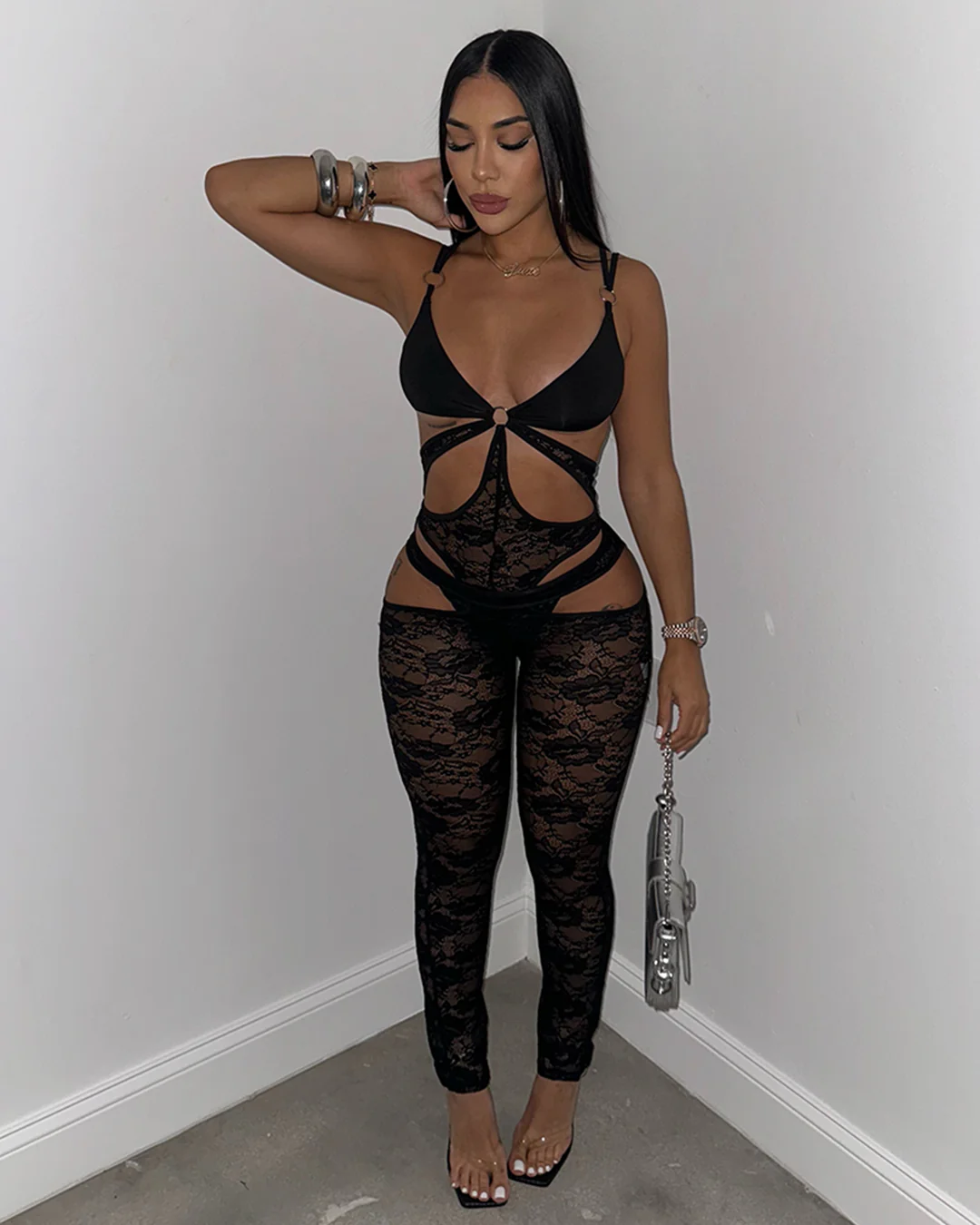 Model wearing Siya Lace Jumpsuit in black, featuring a daring cut-out design with lace leggings and adjustable straps. Perfect for bold, sultry looks.