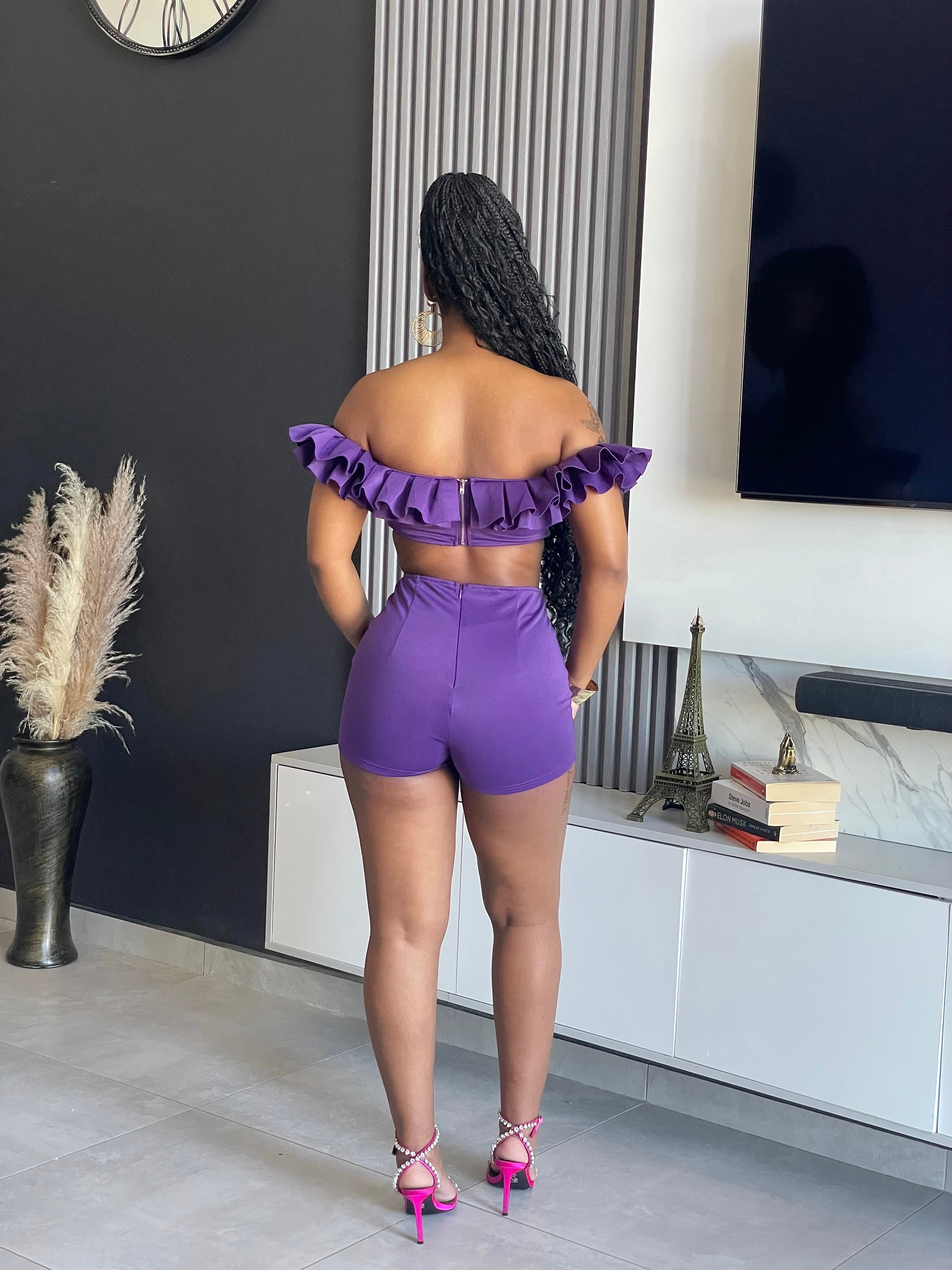 May Ruffle Short Set with off-shoulder ruffle crop top and high-waisted purple shorts.