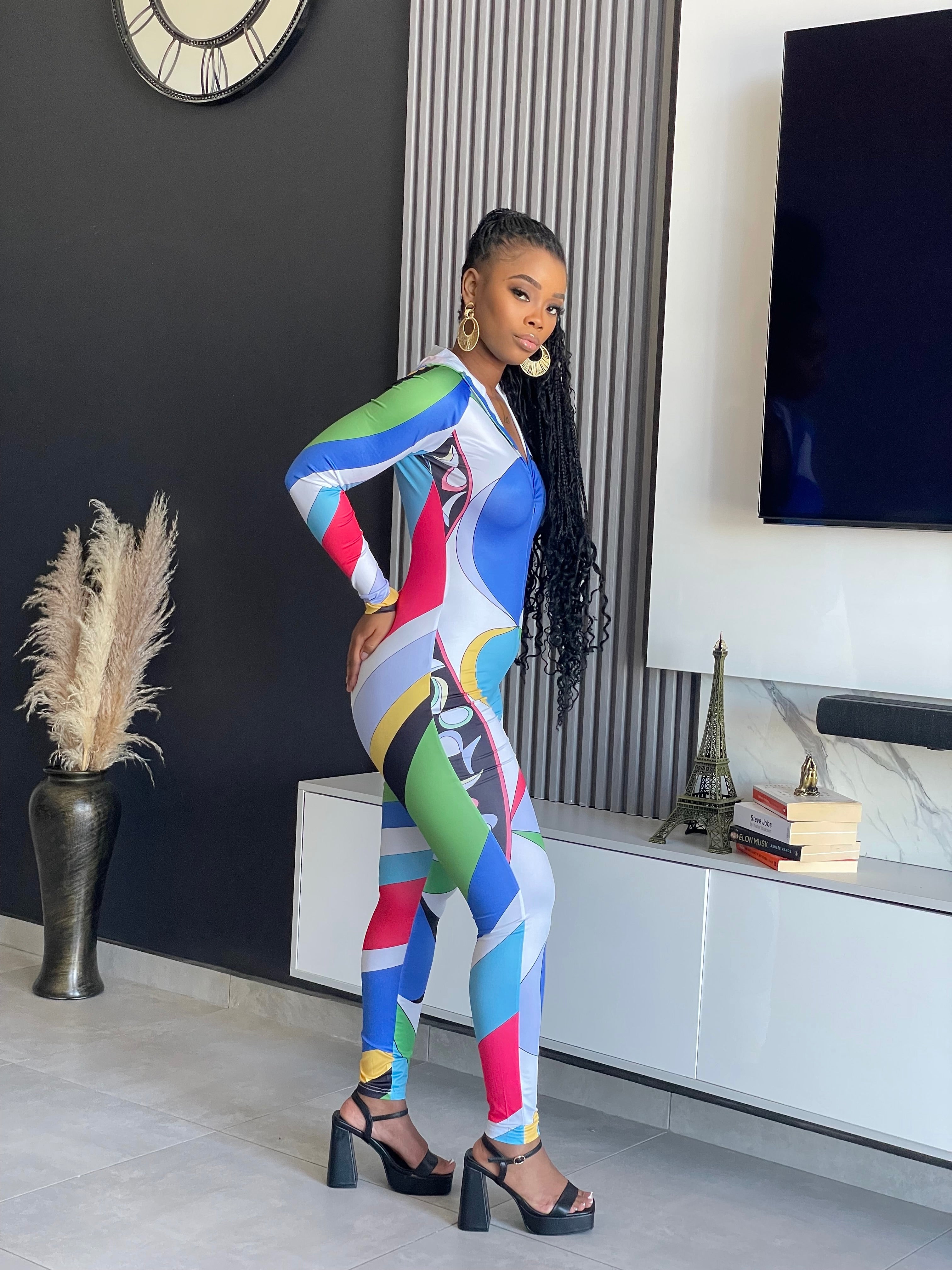 Tejah Jumpsuit with colorful geometric print, zip-up front, and fitted silhouette.