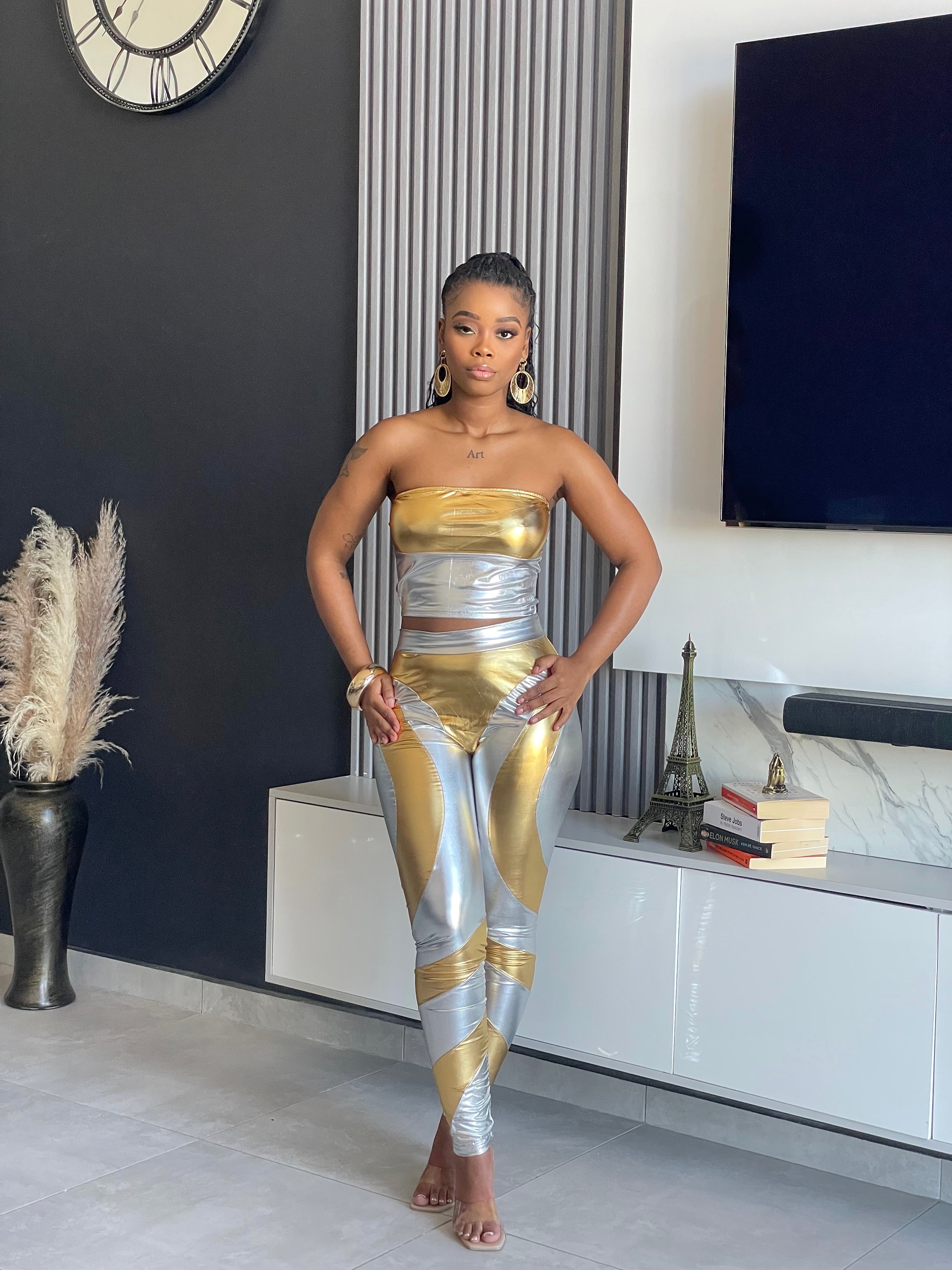 Split Decision Metallic Pant Set with strapless gold top and silver high-waisted leggings.