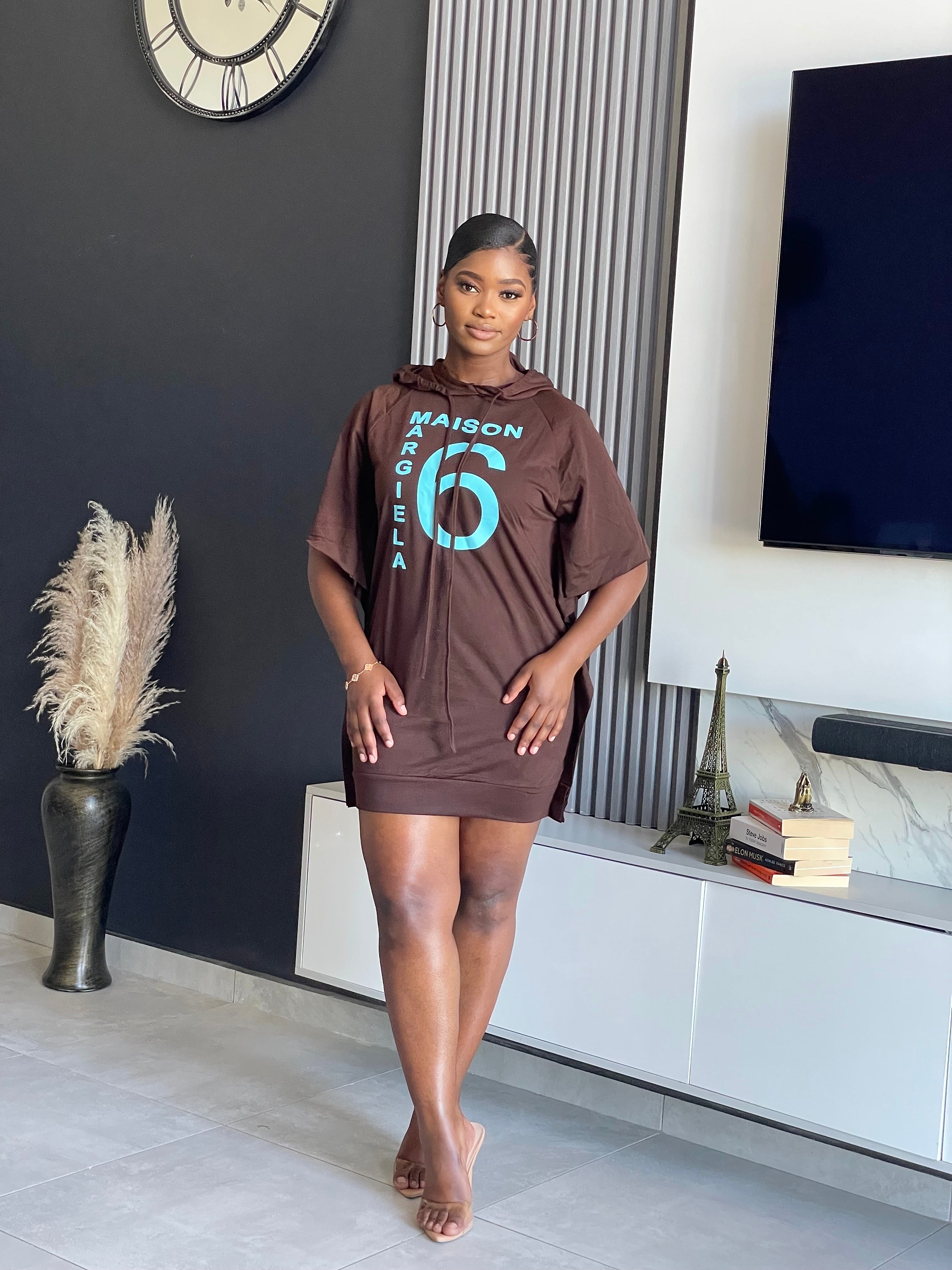 Oversized Maison Hoodie Dress in chocolate brown with turquoise graphic print and hooded design.