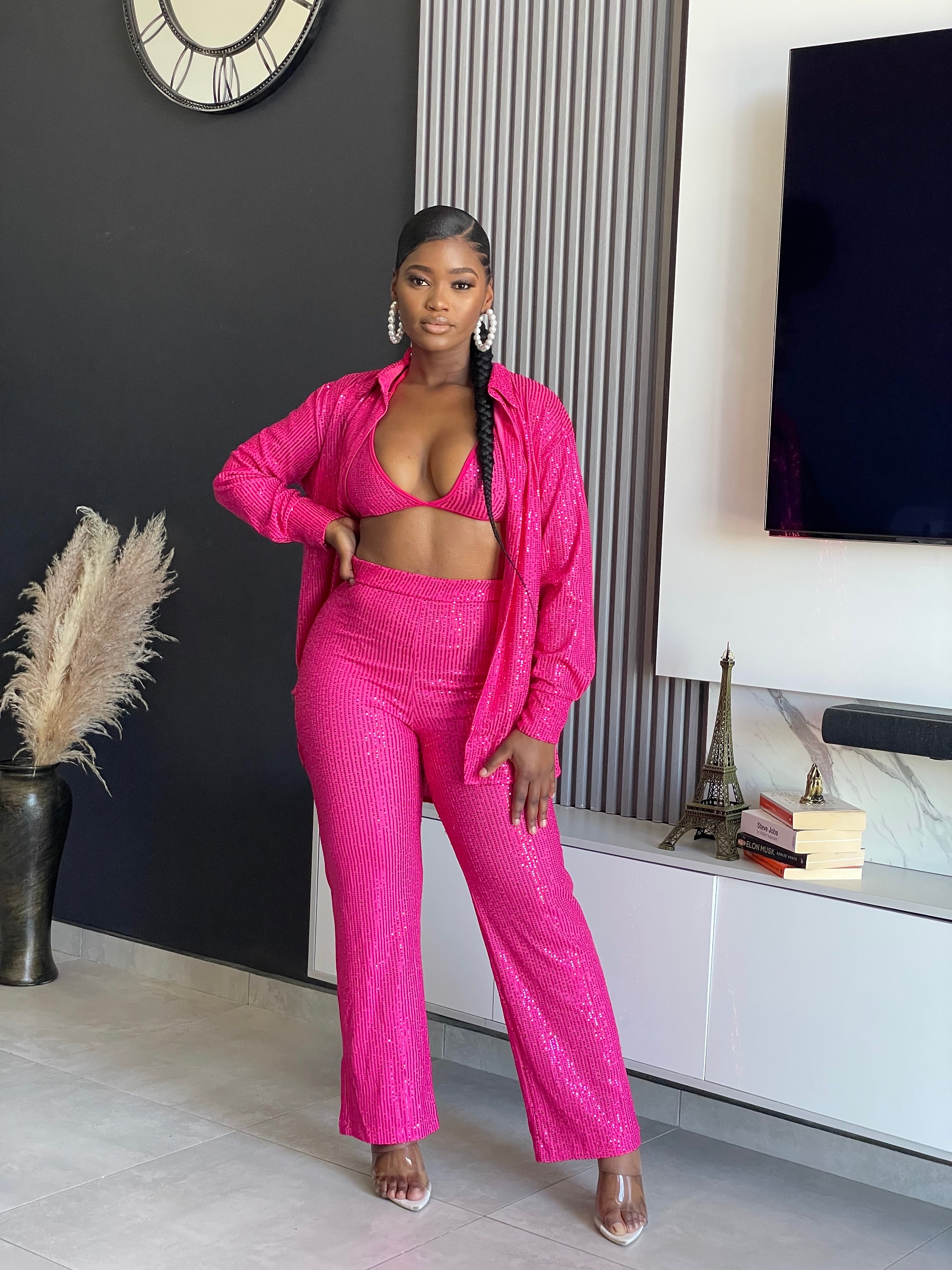 A woman wearing the My First Choice Sequin Pant Set in vibrant pink, featuring a sequin blazer and pants, ideal for making a glamorous fashion statement at any party.