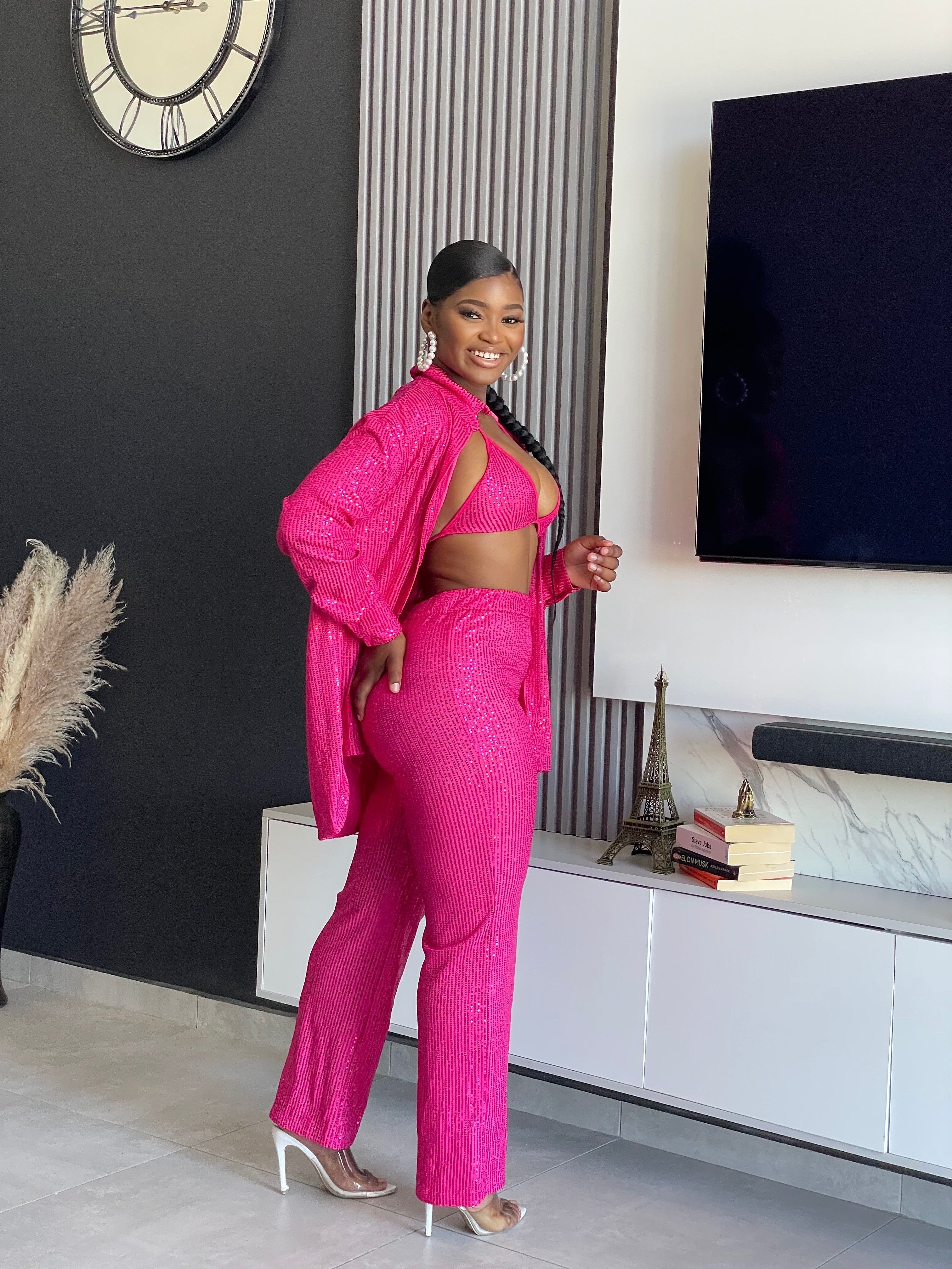 A woman wearing the My First Choice Sequin Pant Set in vibrant pink, featuring a sequin blazer and pants, ideal for making a glamorous fashion statement at any party.