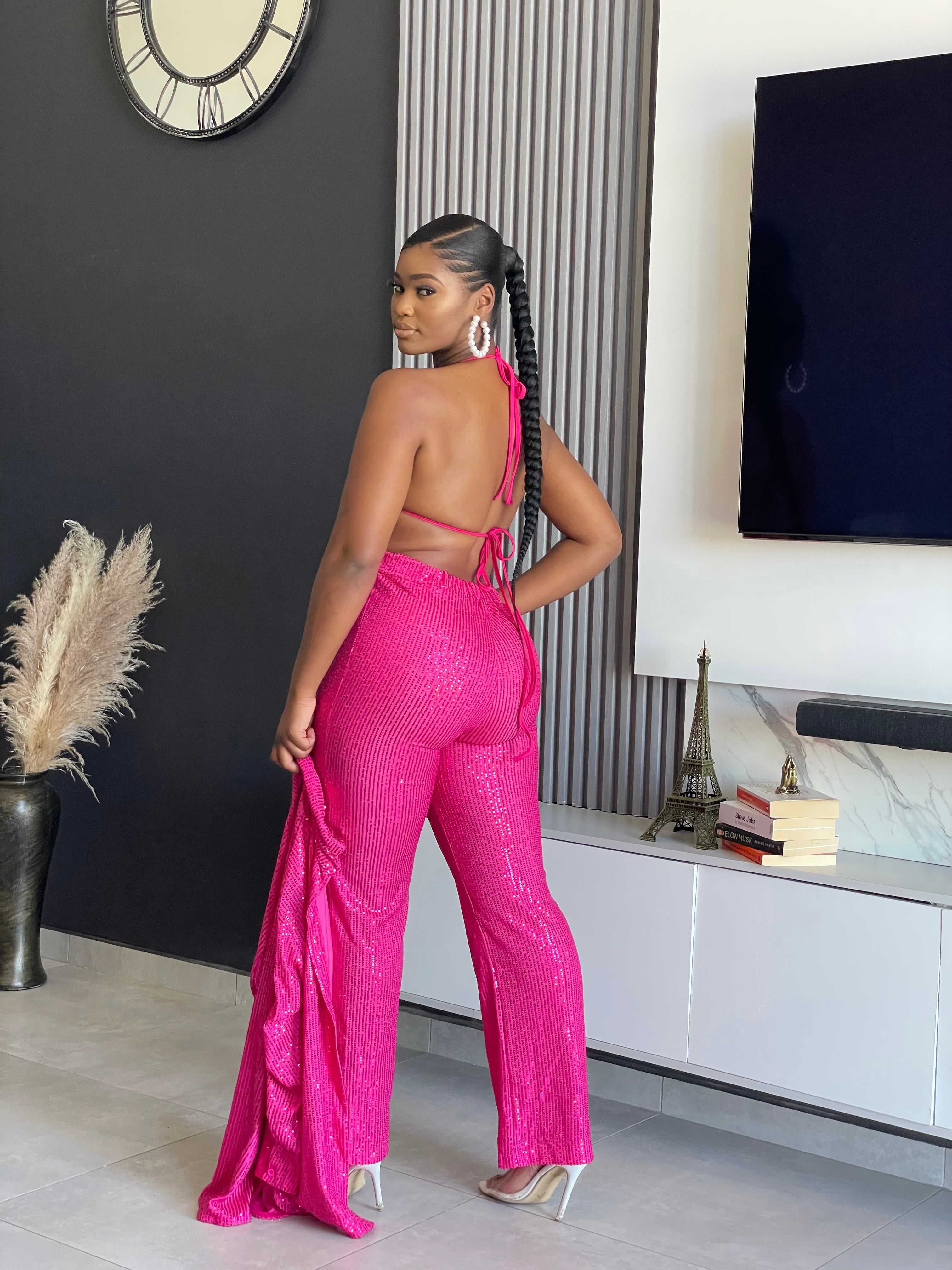 A woman wearing the My First Choice Sequin Pant Set in vibrant pink, featuring a sequin blazer and pants, ideal for making a glamorous fashion statement at any party.