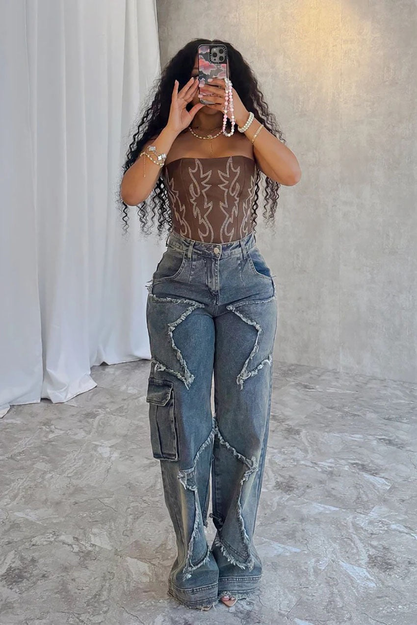 Woman wearing Gina Distressed Denim Jeans with bold distressed details