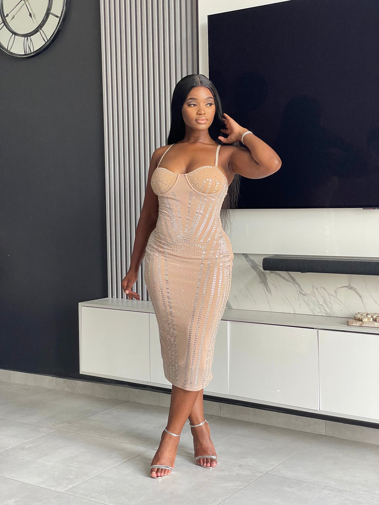 Model wearing the Amoy Midi Dress in nude with rhinestone embellishments and a structured bustier design, perfect for formal occasions and parties.