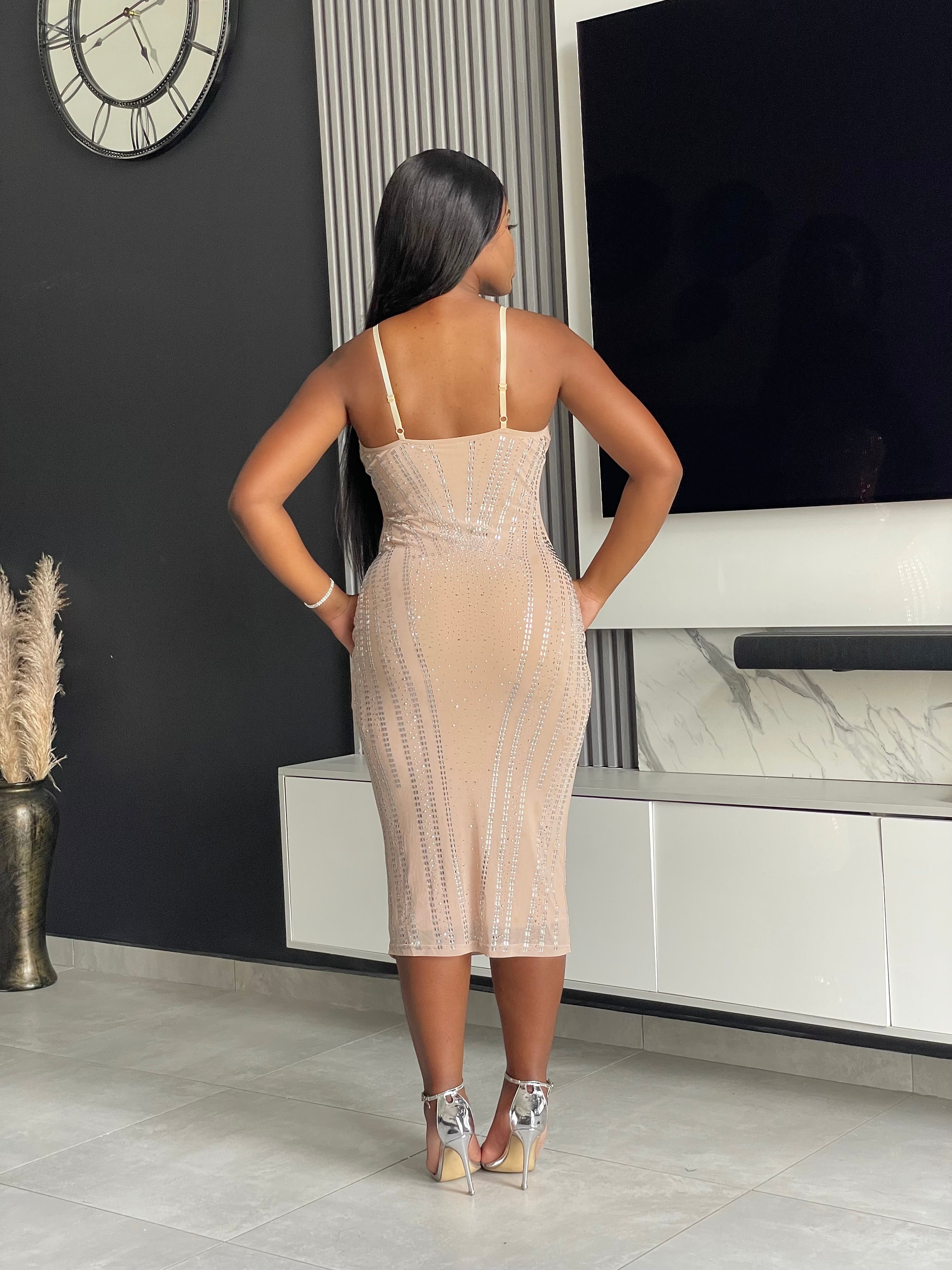 Model wearing the Amoy Midi Dress in nude with rhinestone embellishments and a structured bustier design, perfect for formal occasions and parties.