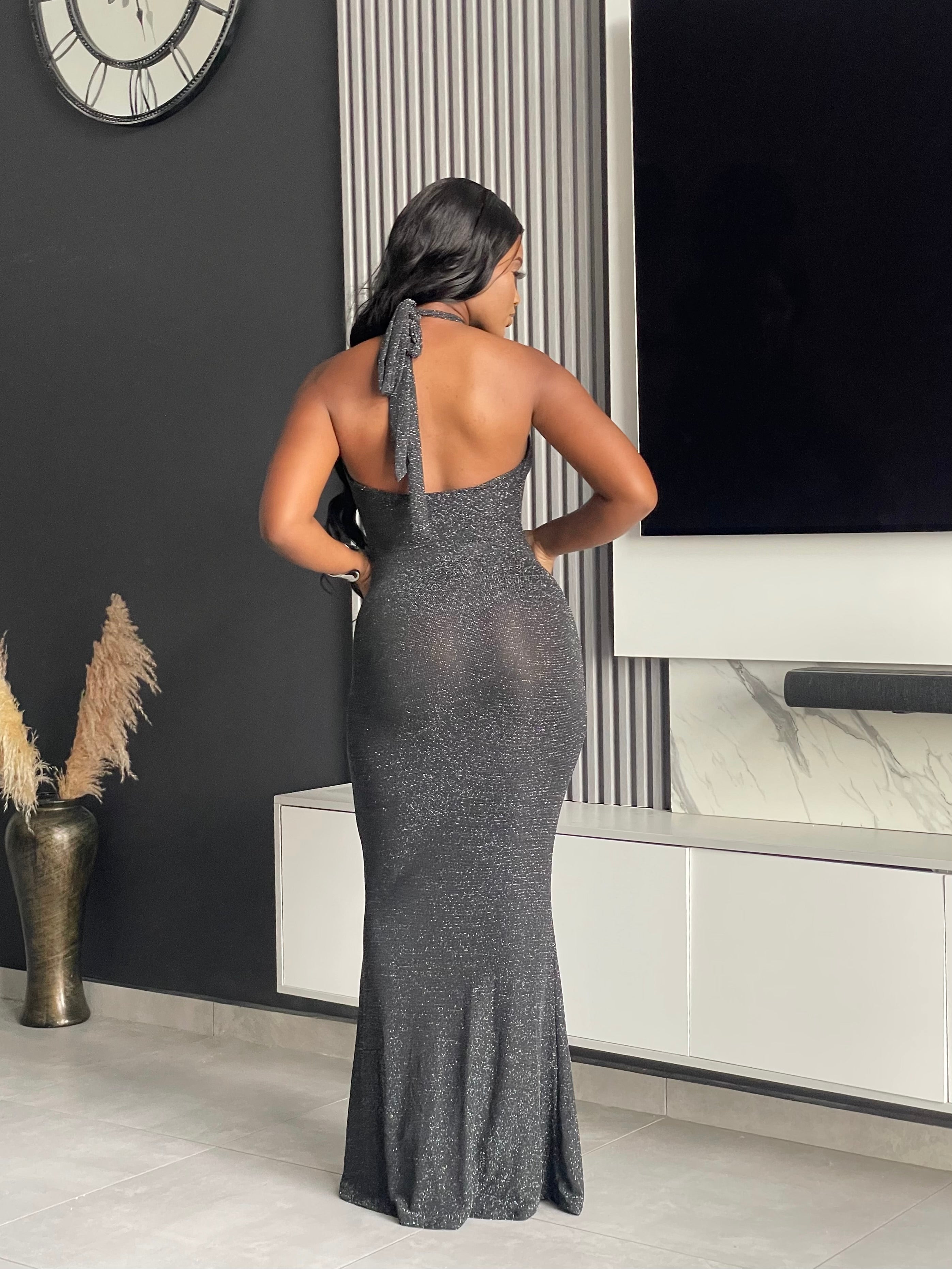 Model wearing Winners Circle Maxi Dress in charcoal grey, featuring a glittery finish and elegant cutout, ideal for formal occasions.