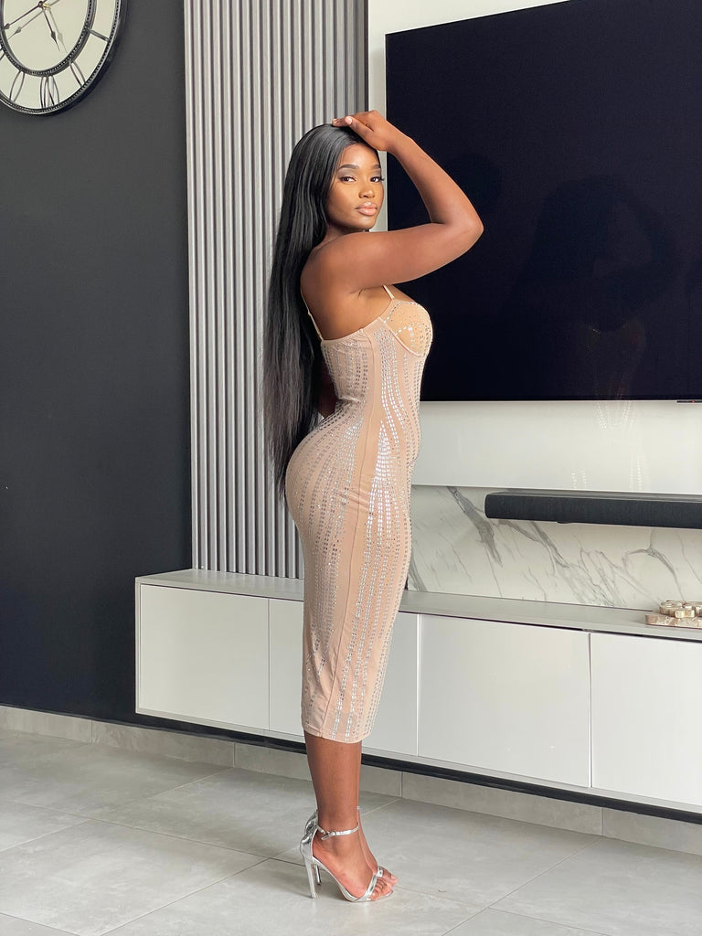 Model wearing the Amoy Midi Dress in nude with rhinestone embellishments and a structured bustier design, perfect for formal occasions and parties.