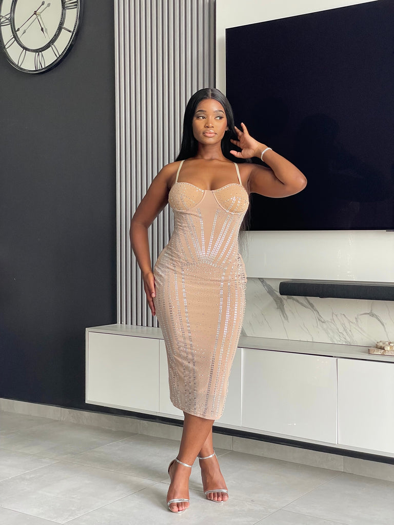 Model wearing the Amoy Midi Dress in nude with rhinestone embellishments and a structured bustier design, perfect for formal occasions and parties.