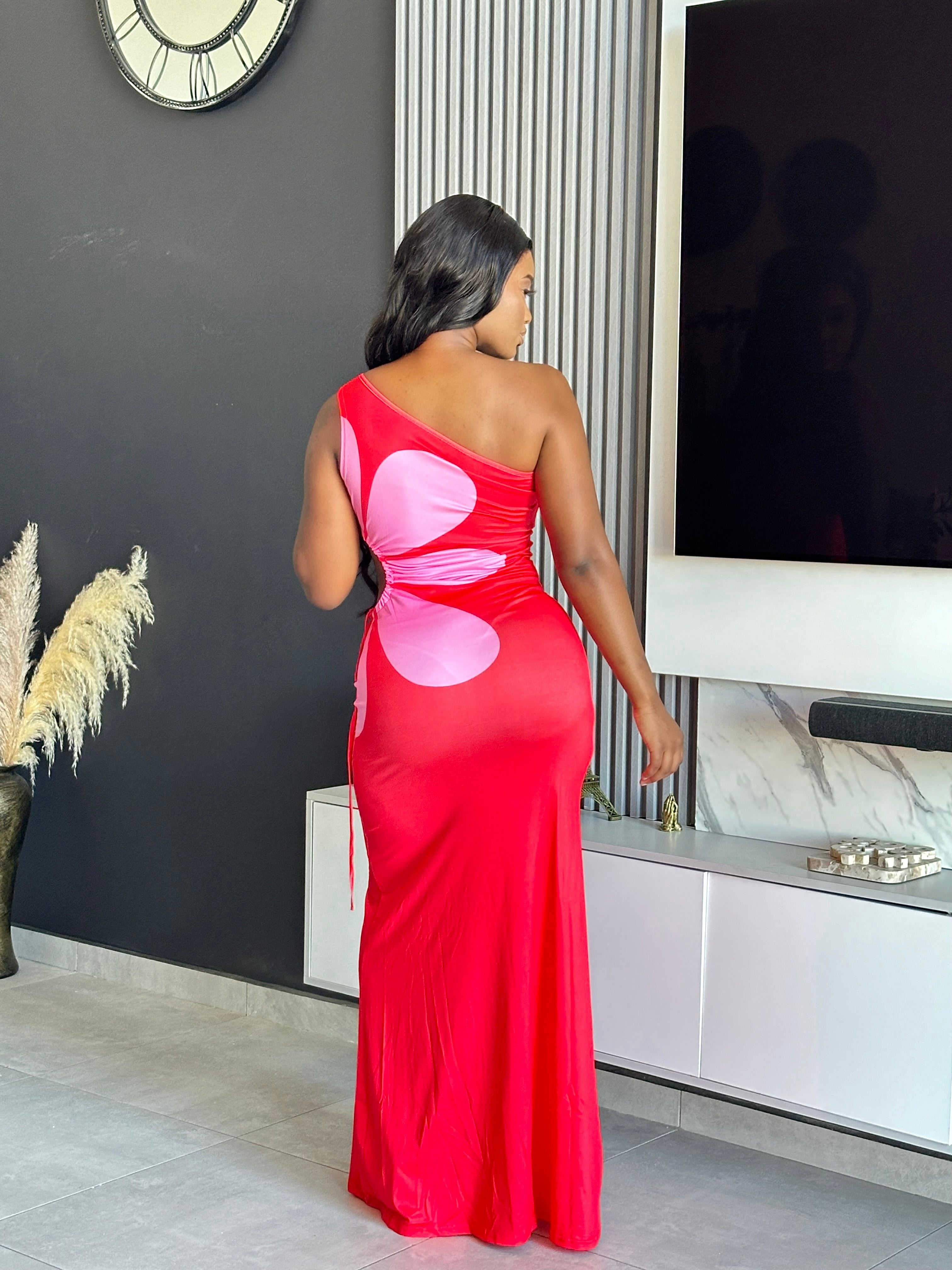 Model wearing the Annabelle Maxi Dress in red and pink with a one-shoulder design.