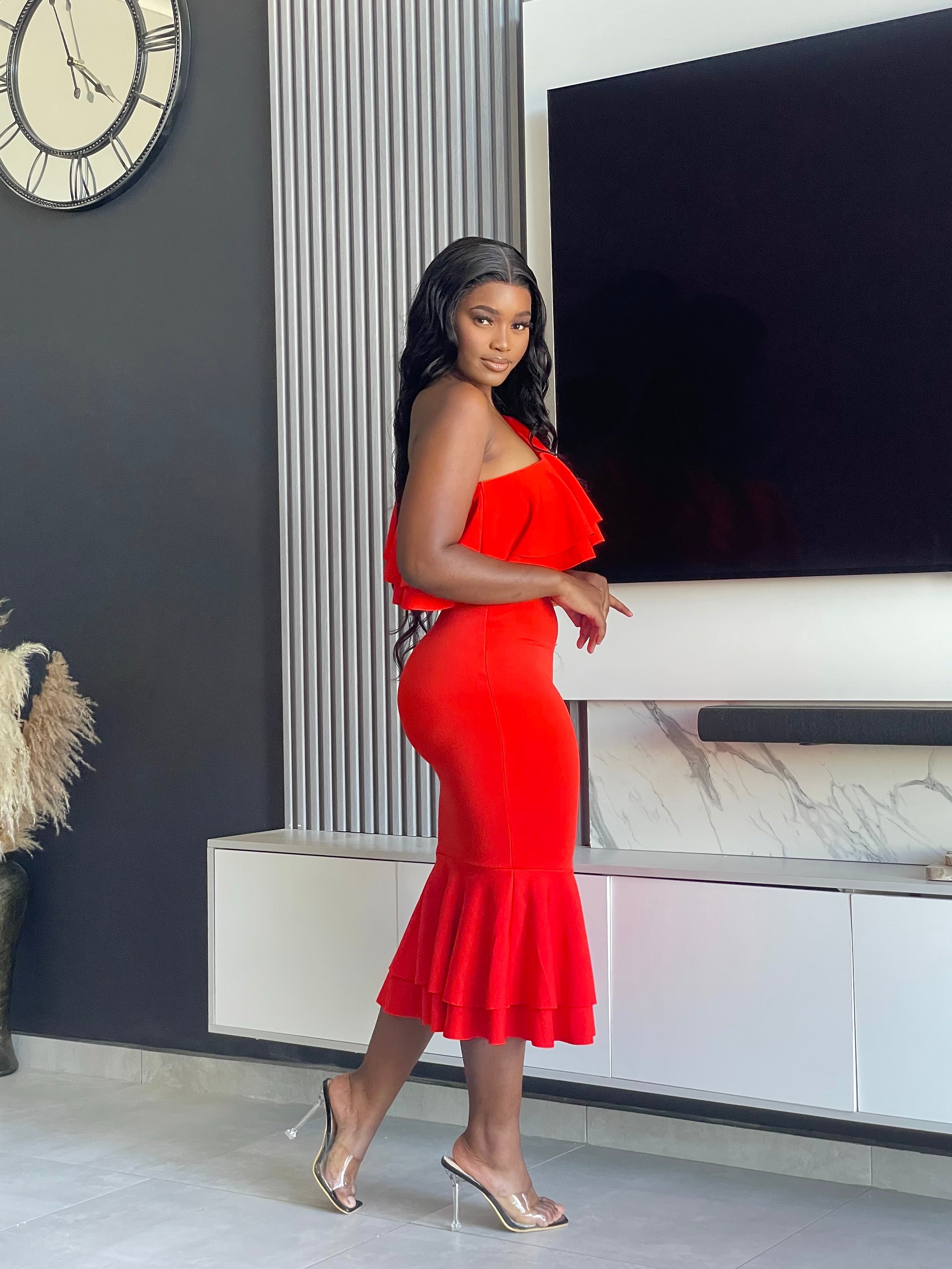 Embrace elegance with the Edeline Midi Dress, featuring a striking red hue and stylish ruffle accents. Perfect for any special occasion or evening event. Shop now!