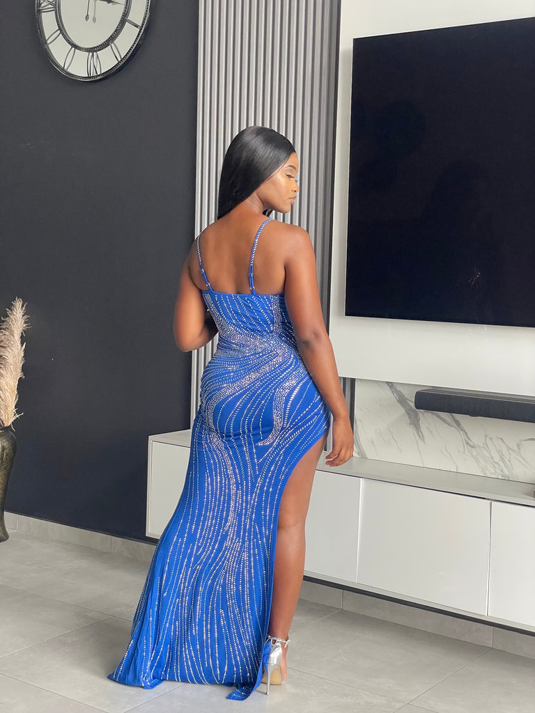 Model wearing the Tejah Maxi Dress in royal blue with sequin details, posing elegantly.