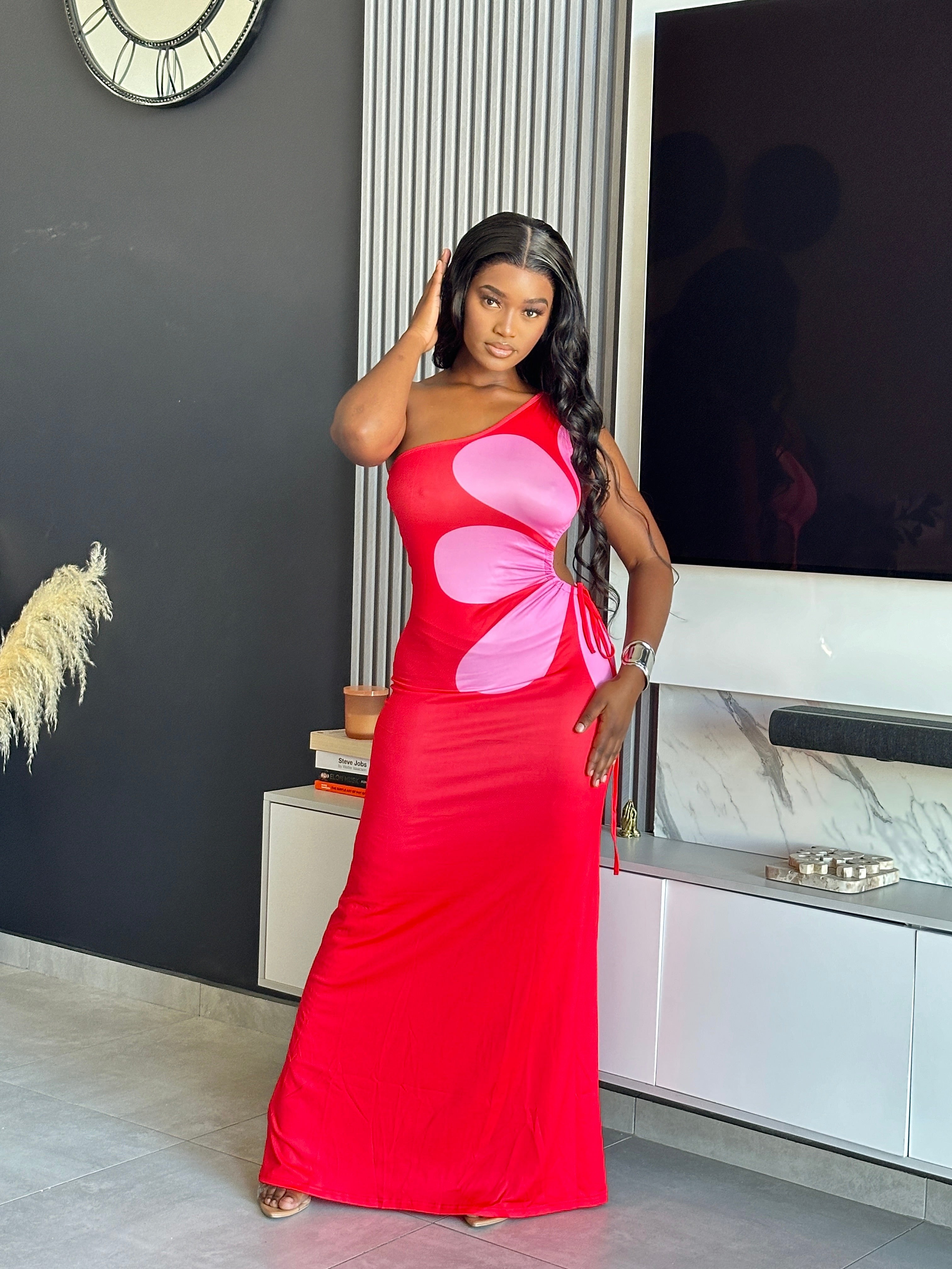 Model wearing the Annabelle Maxi Dress in red and pink with a one-shoulder design.
