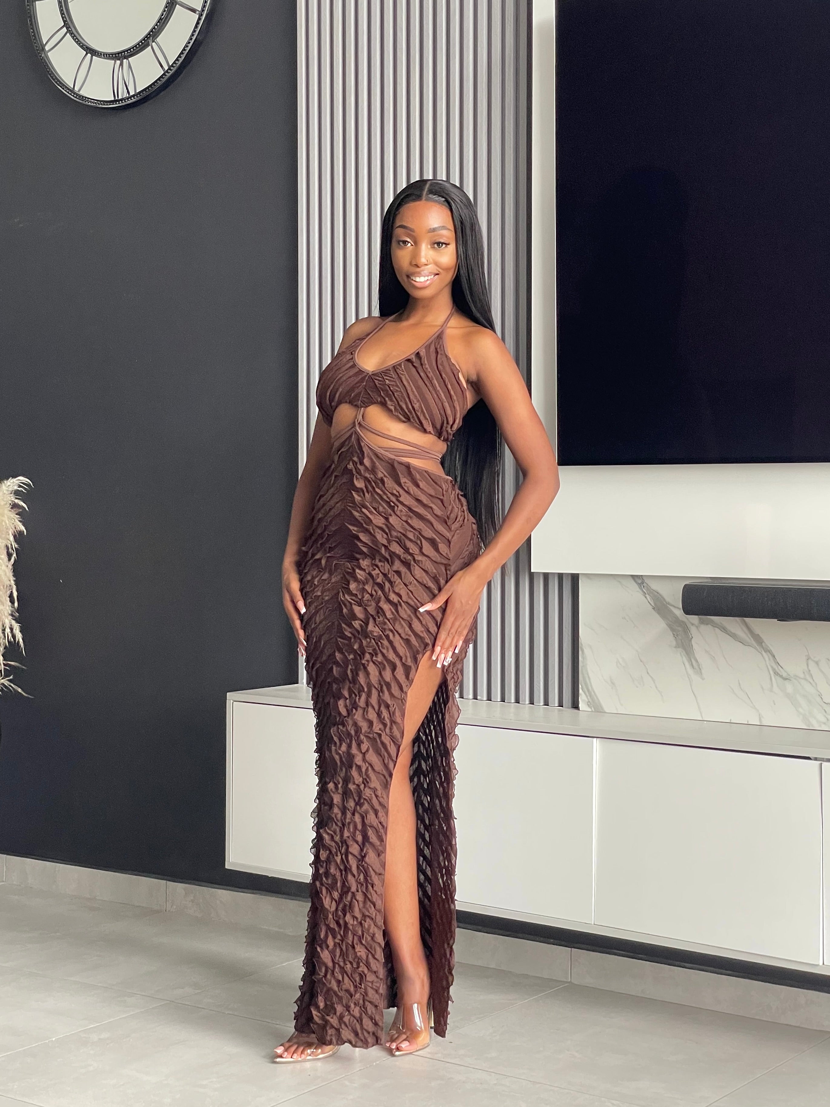 Model wearing the Adorable Maxi Dress in brown with ruffle details, a halter-neck design, and sultry cutouts.