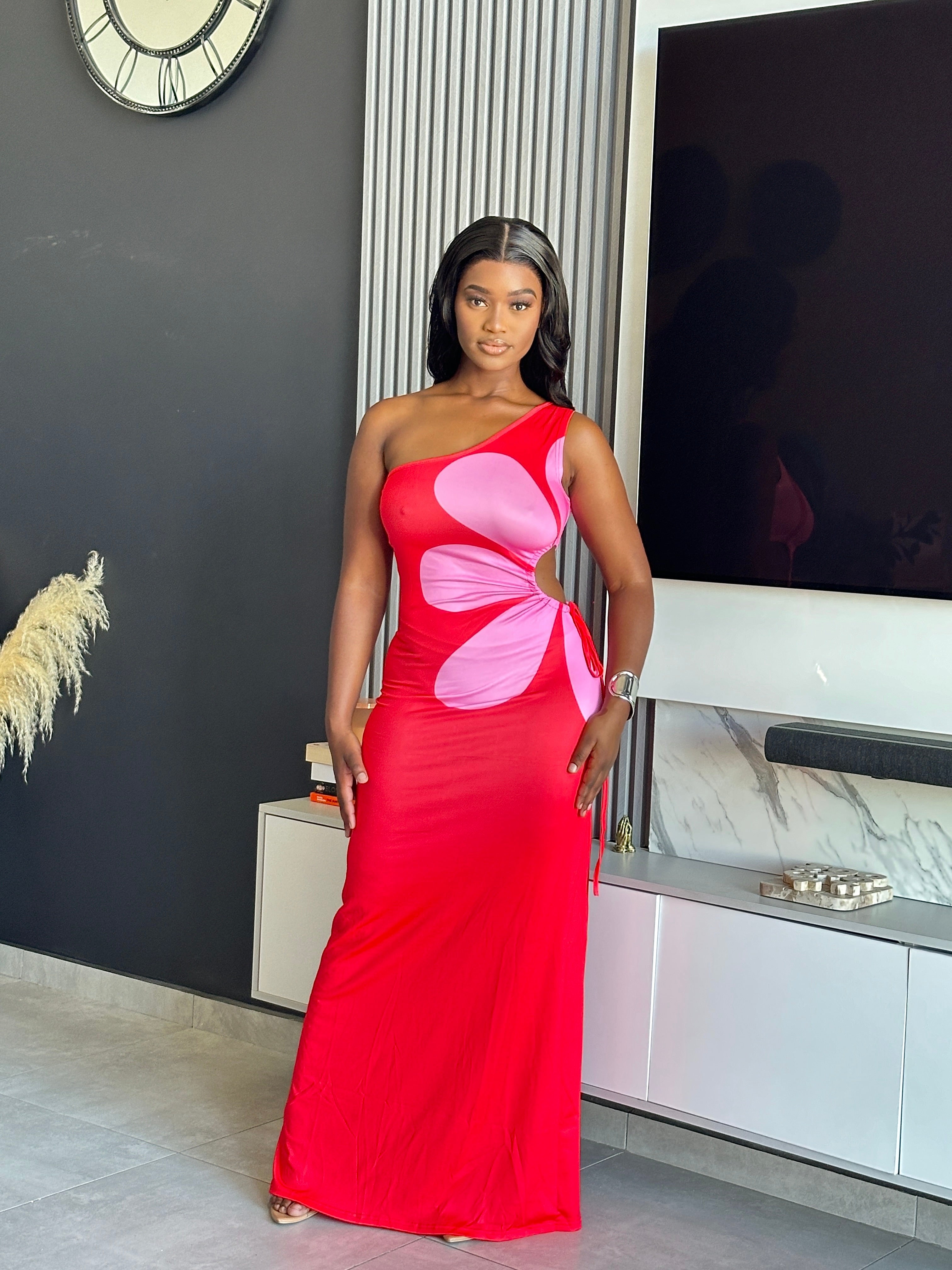 Model wearing the Annabelle Maxi Dress in red and pink with a one-shoulder design.