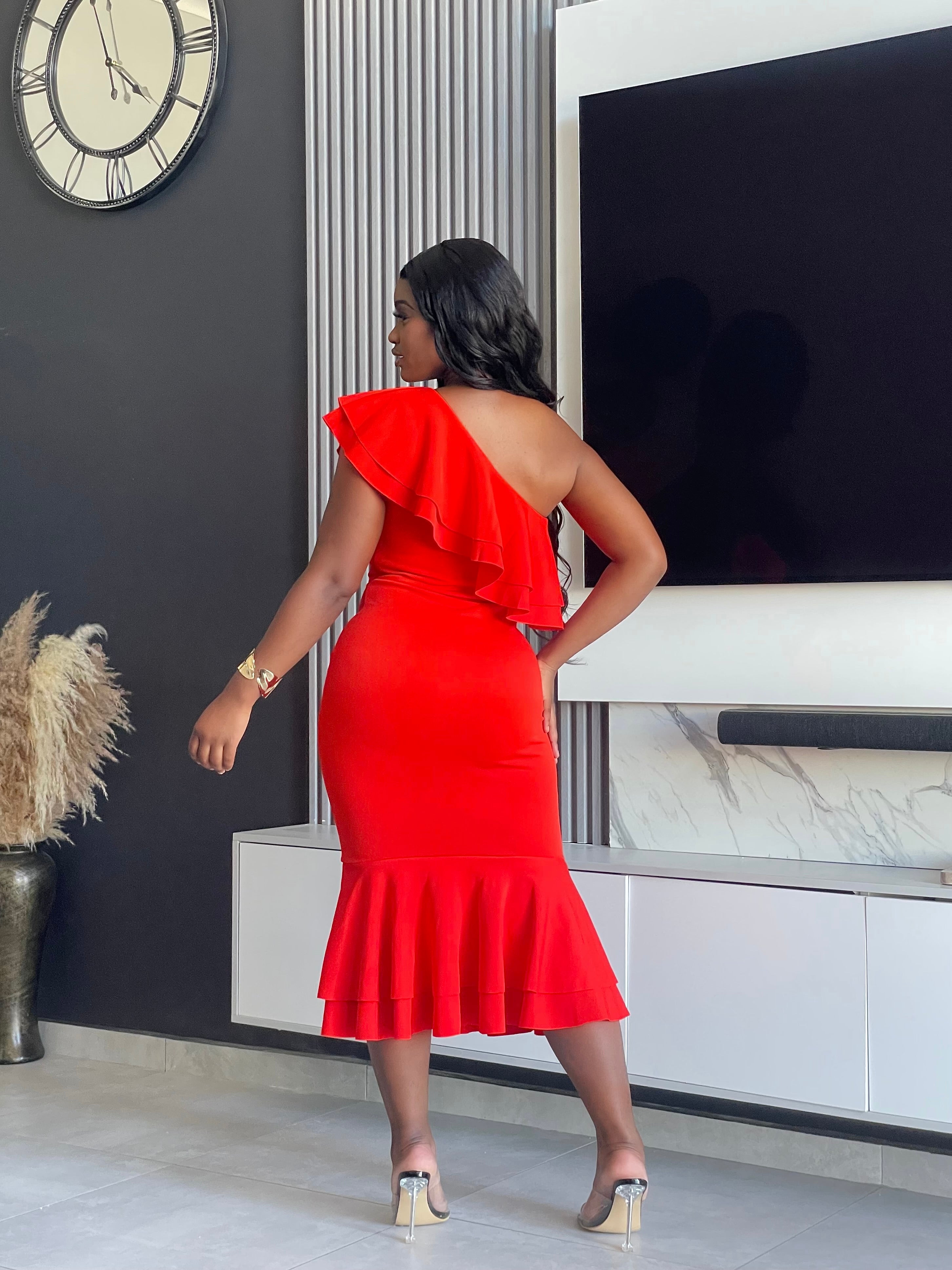 Embrace elegance with the Edeline Midi Dress, featuring a striking red hue and stylish ruffle accents. Perfect for any special occasion or evening event. Shop now!