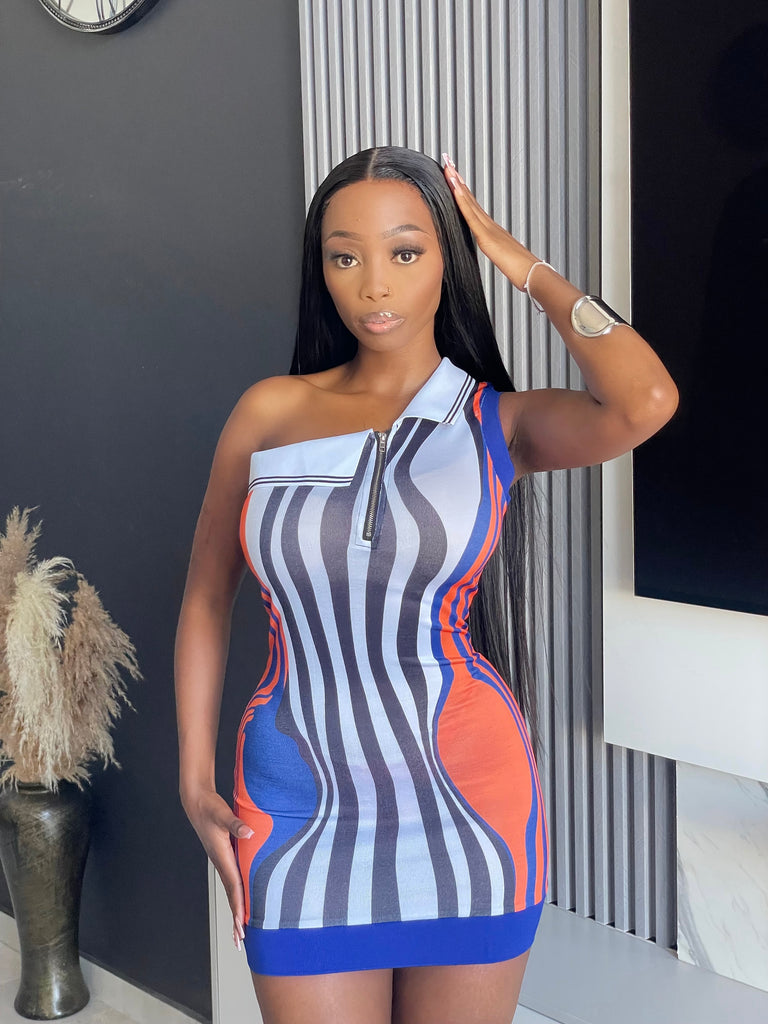 Model wearing the Roselle Mini Dress, featuring a vibrant geometric stripe pattern in blue, orange, and grey, perfect for party wear.