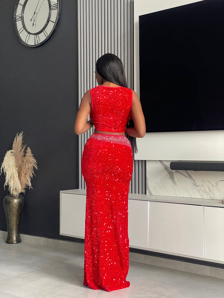 Model wearing the Sequoia Skirt Set in red, a two-piece outfit with a sequin crop top and skirt, ideal for glamorous evenings and special events.