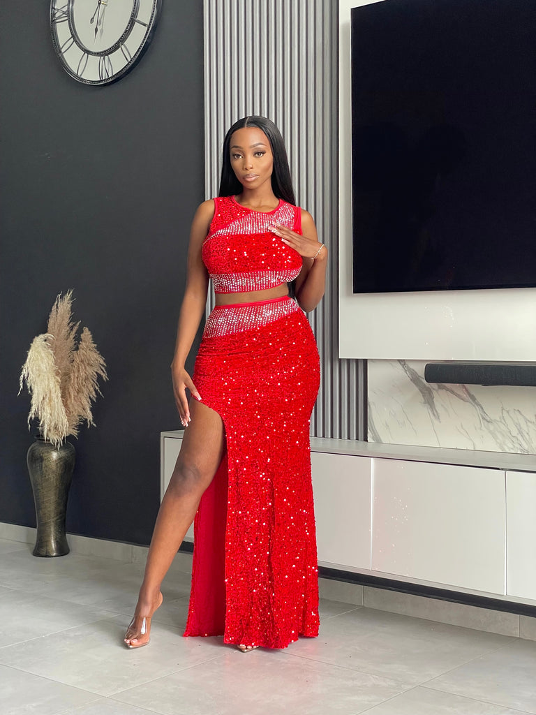 Model wearing the Sequoia Skirt Set in red, a two-piece outfit with a sequin crop top and skirt, ideal for glamorous evenings and special events.