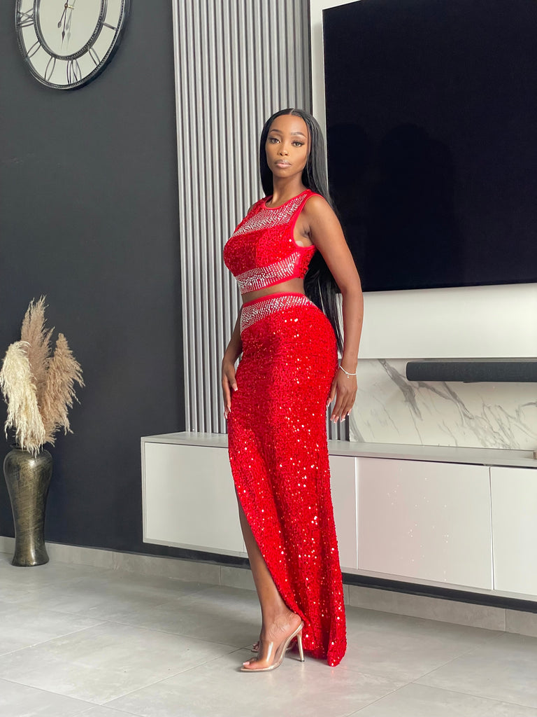 Model wearing the Sequoia Skirt Set in red, a two-piece outfit with a sequin crop top and skirt, ideal for glamorous evenings and special events.