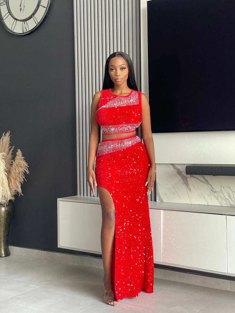 Model wearing the Sequoia Skirt Set in red, a two-piece outfit with a sequin crop top and skirt, ideal for glamorous evenings and special events.