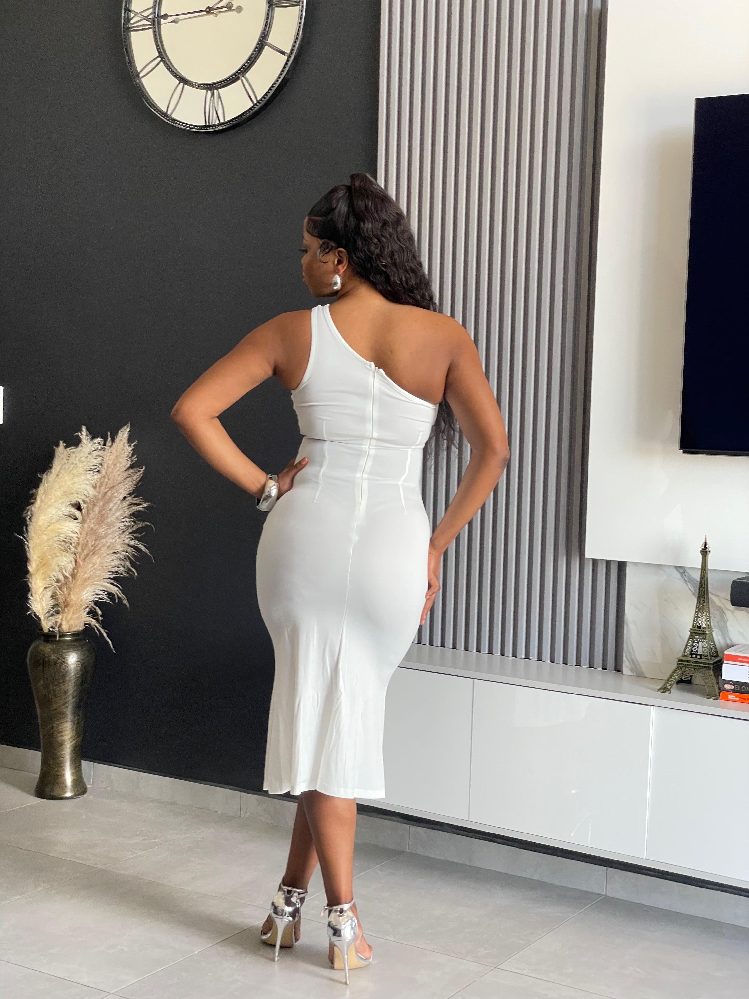 A woman wearing the Dariana Elegant Midi Dress in white, featuring a one-shoulder design and a side slit, ideal for formal and cocktail events