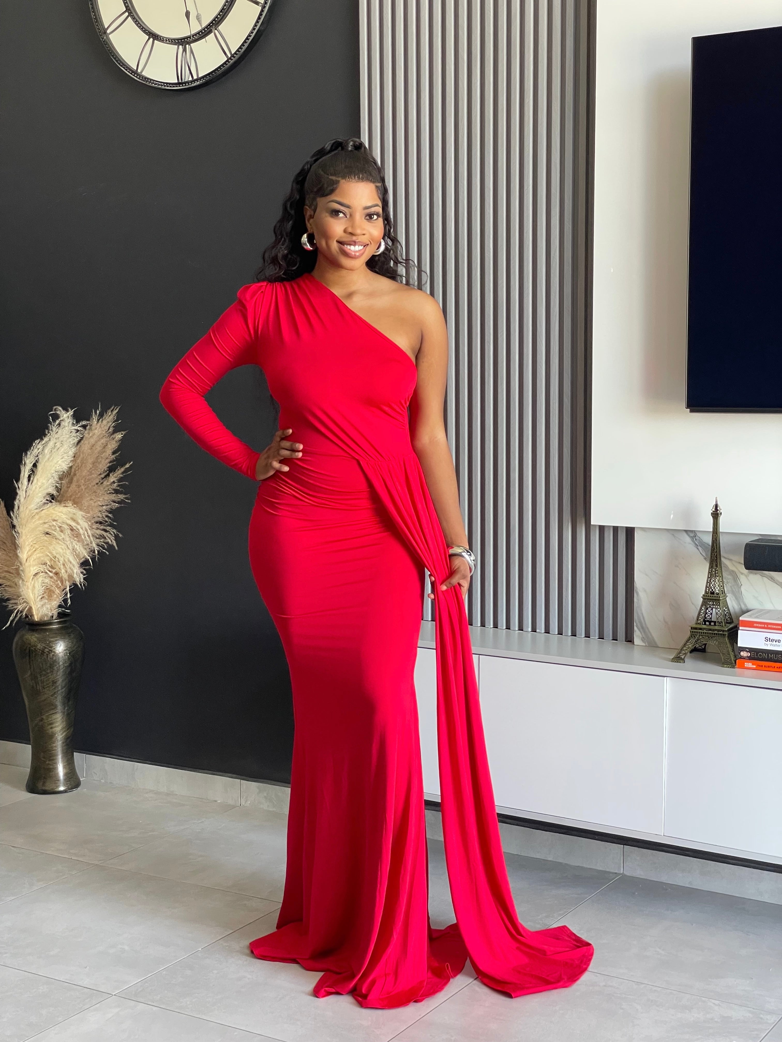 A woman wearing the Londyn Elegant Maxi Dress in rich red, featuring a one-shoulder design and flowing silhouette, ideal for formal occasions and galas